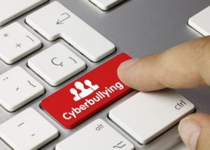 Cyberbullying keyboard key. Finger