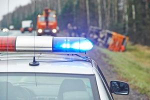 police car with a flasher at lorry crash