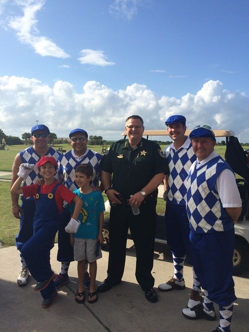 Members of Widerman Malek pictured with [url=http://www.brevardsheriff.com/home/meet-the-sheriff-wayne-ivey/]Sheriff Wayne Ivey[/url]. Mark Malek’s sons were caddies for the event.