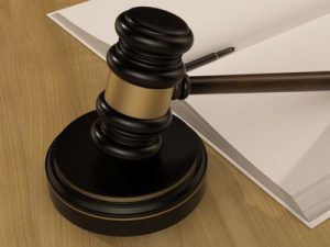 Wooden Judges Gavel And open book on the wooden background