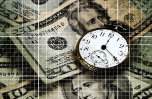 An old pocket watch over US currency. Grid lines throughout in this time and money concept image.