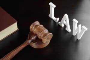 Judges Gavel, Red Book And Sign LAW On Black Table