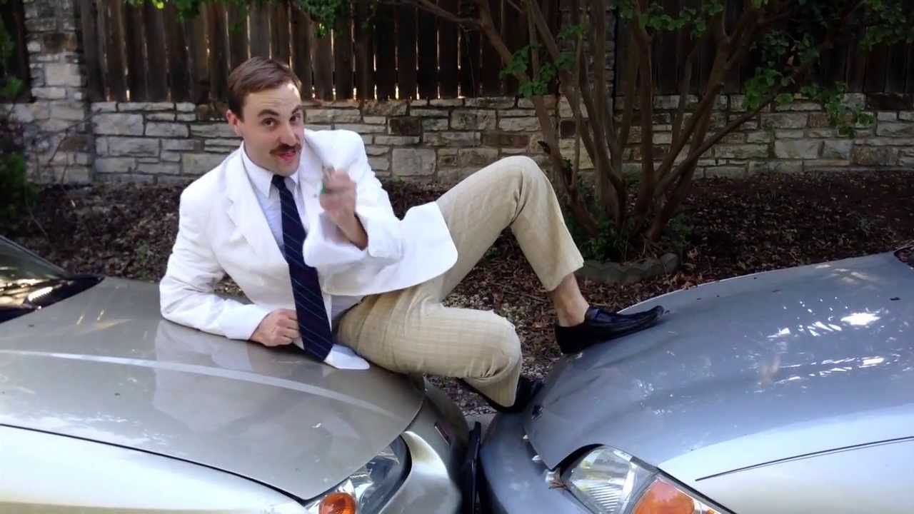 Man sitting on top of a car